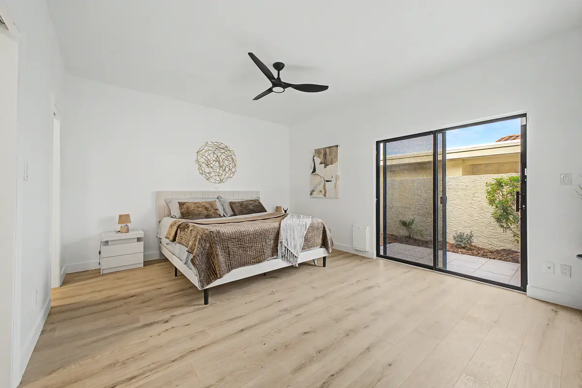 Primary bedroom with patio slider after renovation, Scottsdale Monterey